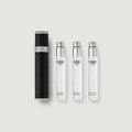 Set of Creed perfume bottles on a light gray background