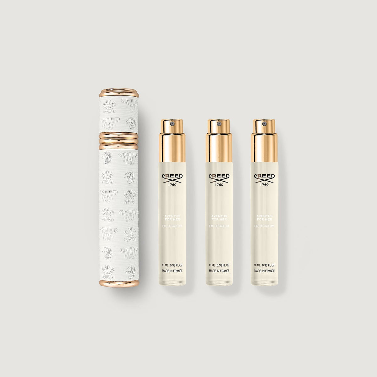 Set of Creed perfume bottles and packaging on a light gray background