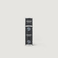 Black and silver cylindrical product on a light gray background