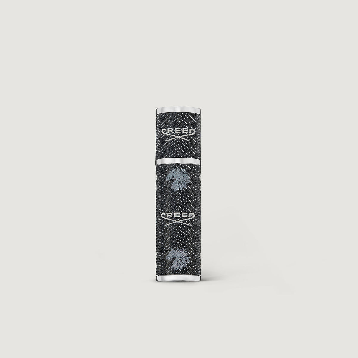 Black and silver cylindrical product on a light gray background