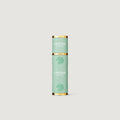 Green Creed perfume atomizer on a light gray background