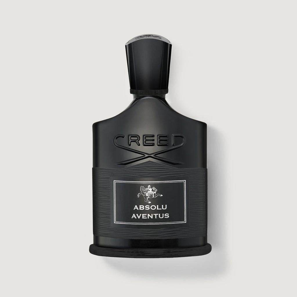Black Creed Absolu Aventus perfume bottle on a light gray background