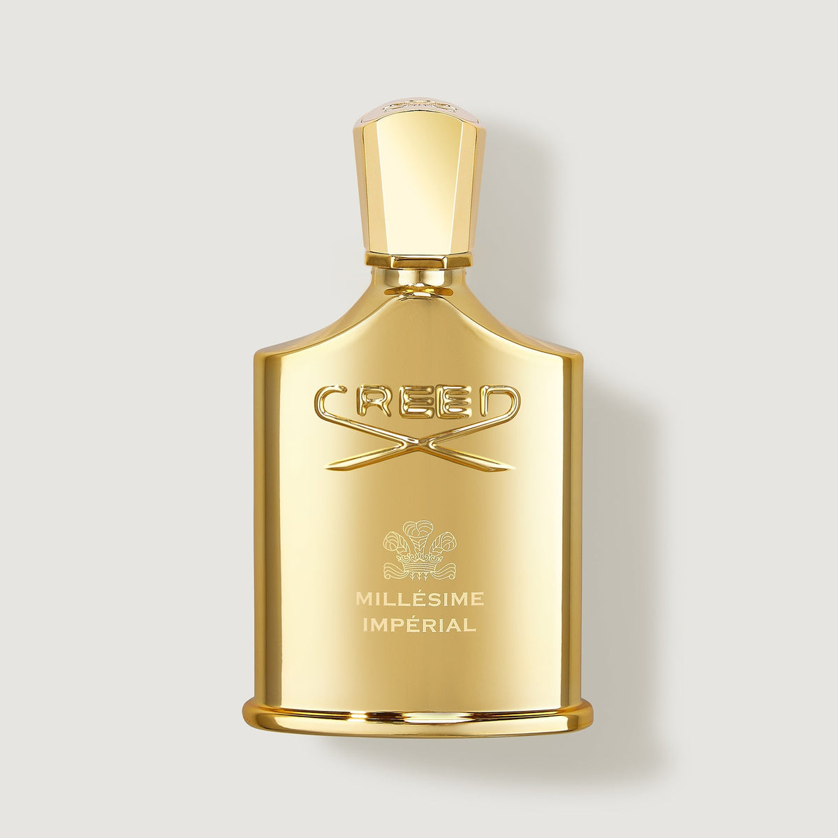 Gold Creed Millesime Imperial perfume bottle on a light gray background